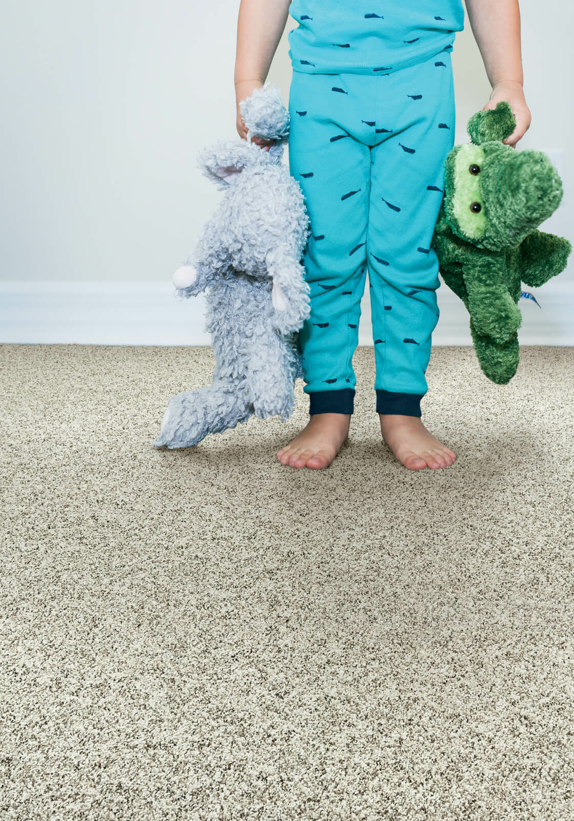 Kid with toys standing on soft carpet | About Floors N' More